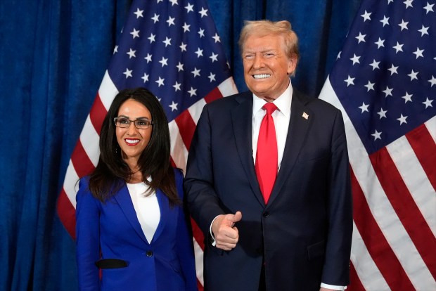 Republican presidential nominee former President Donald Trump poses for a photo with Rep. Lauren Boebert, R-Colo., before he speaks at a campaign rally at the Gaylord Rockies Resort & Convention Center, Friday, Oct. 11, 2024, in Aurora, Colo. (AP Photo/Alex Brandon)